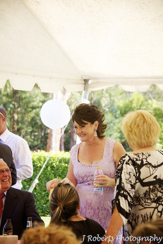 Mother of bride laughing with guests at wedding - wedding photography sydney